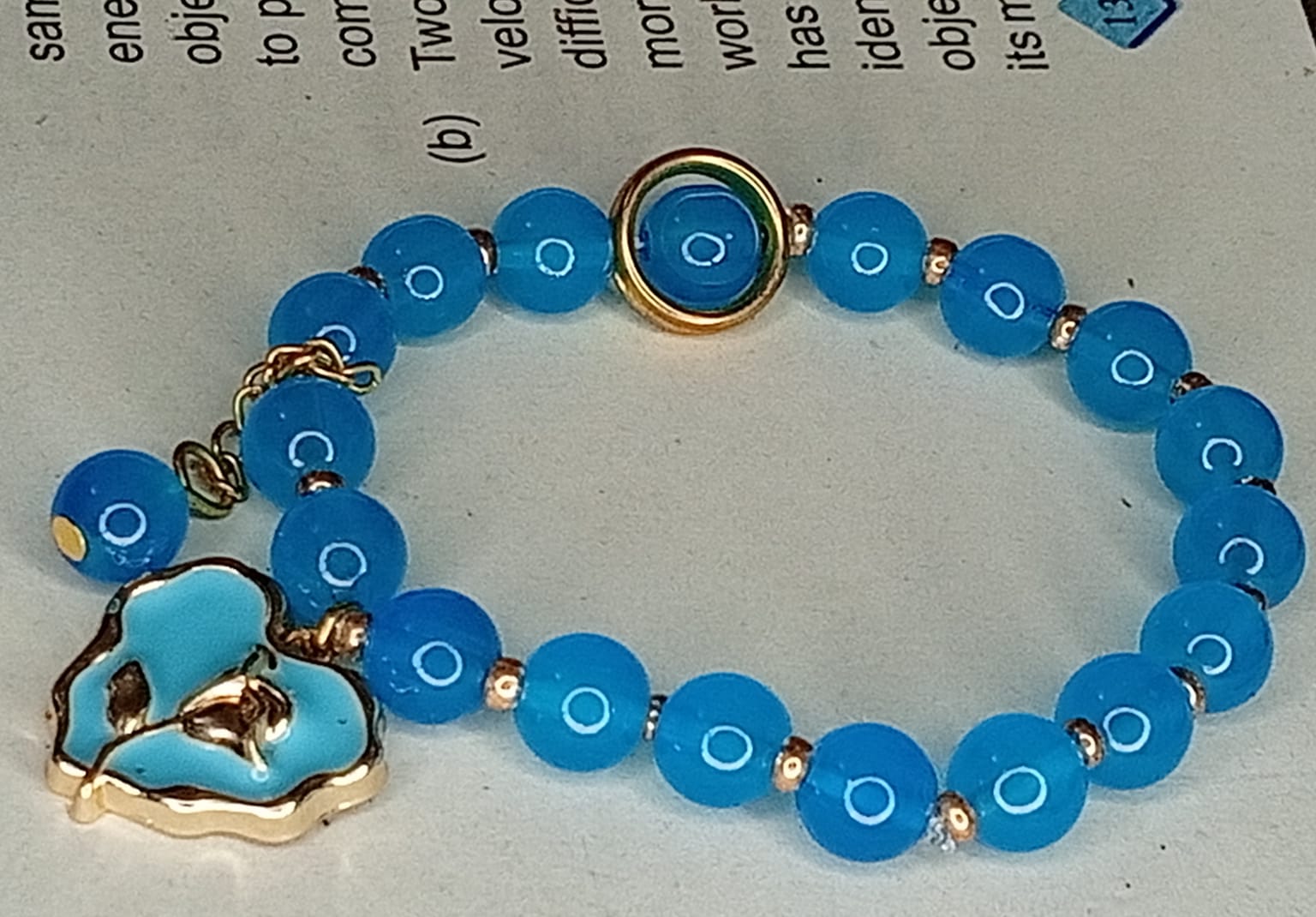 Vibrant Teal Blue Smooth Bead Bracelet with Gold-Trimmed Flower Charm