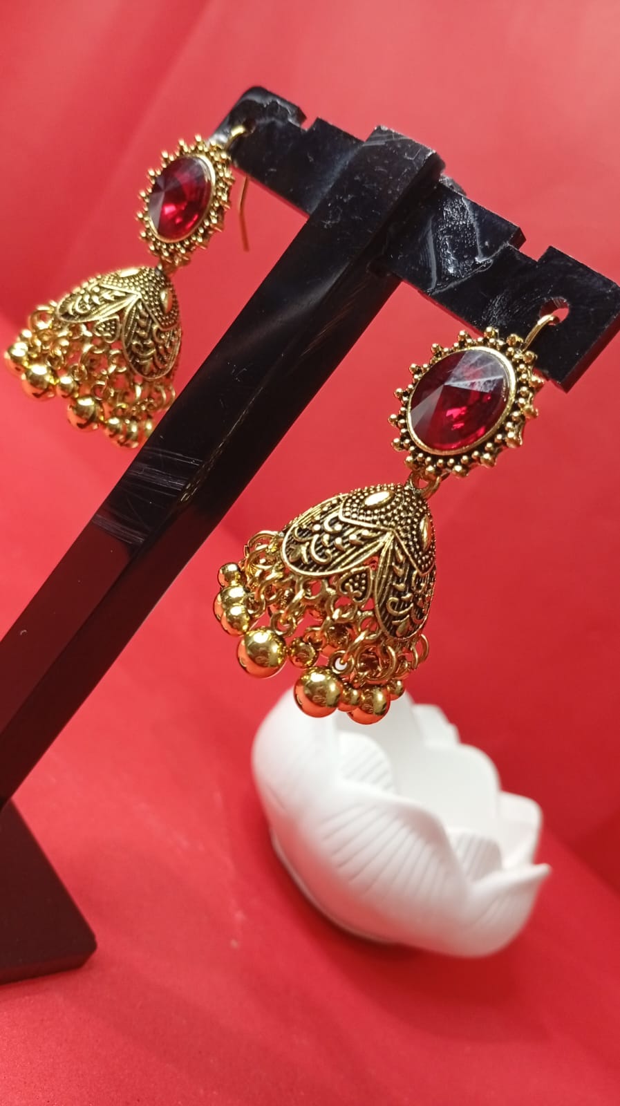 antique gold-tone red stone jhumka earrings
